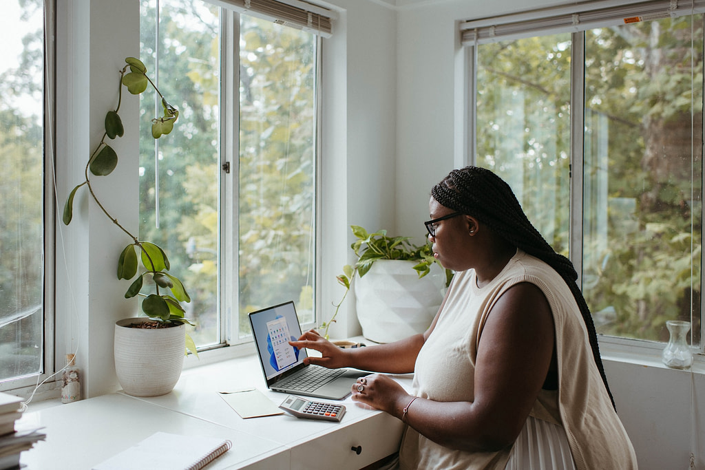 Woman reviewing her blog launch checklist on a laptop.