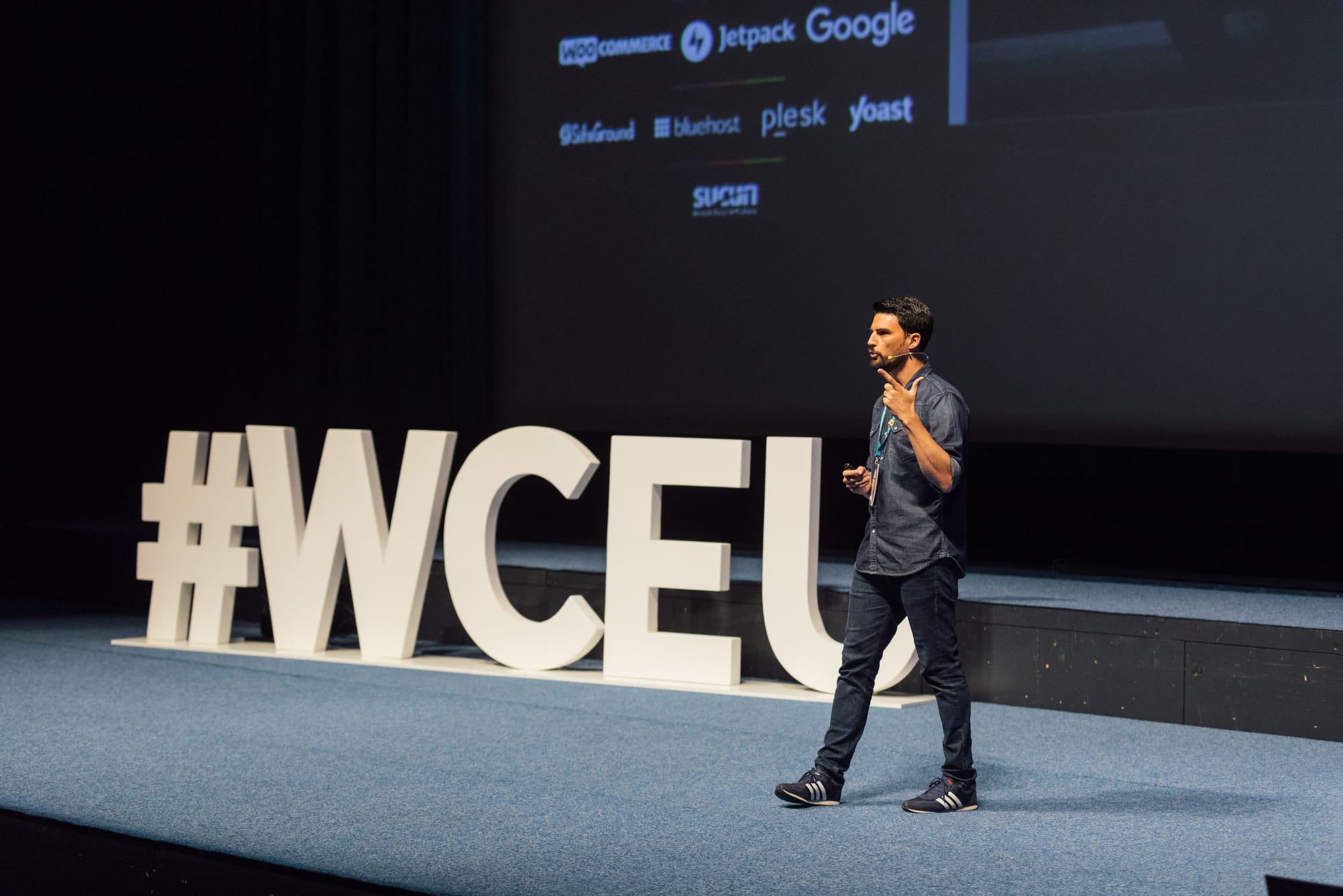 A speaker on stage at WordCamp Europe.