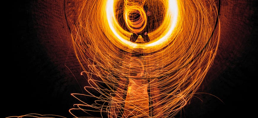 Sparks flying in circles off of a pipe.